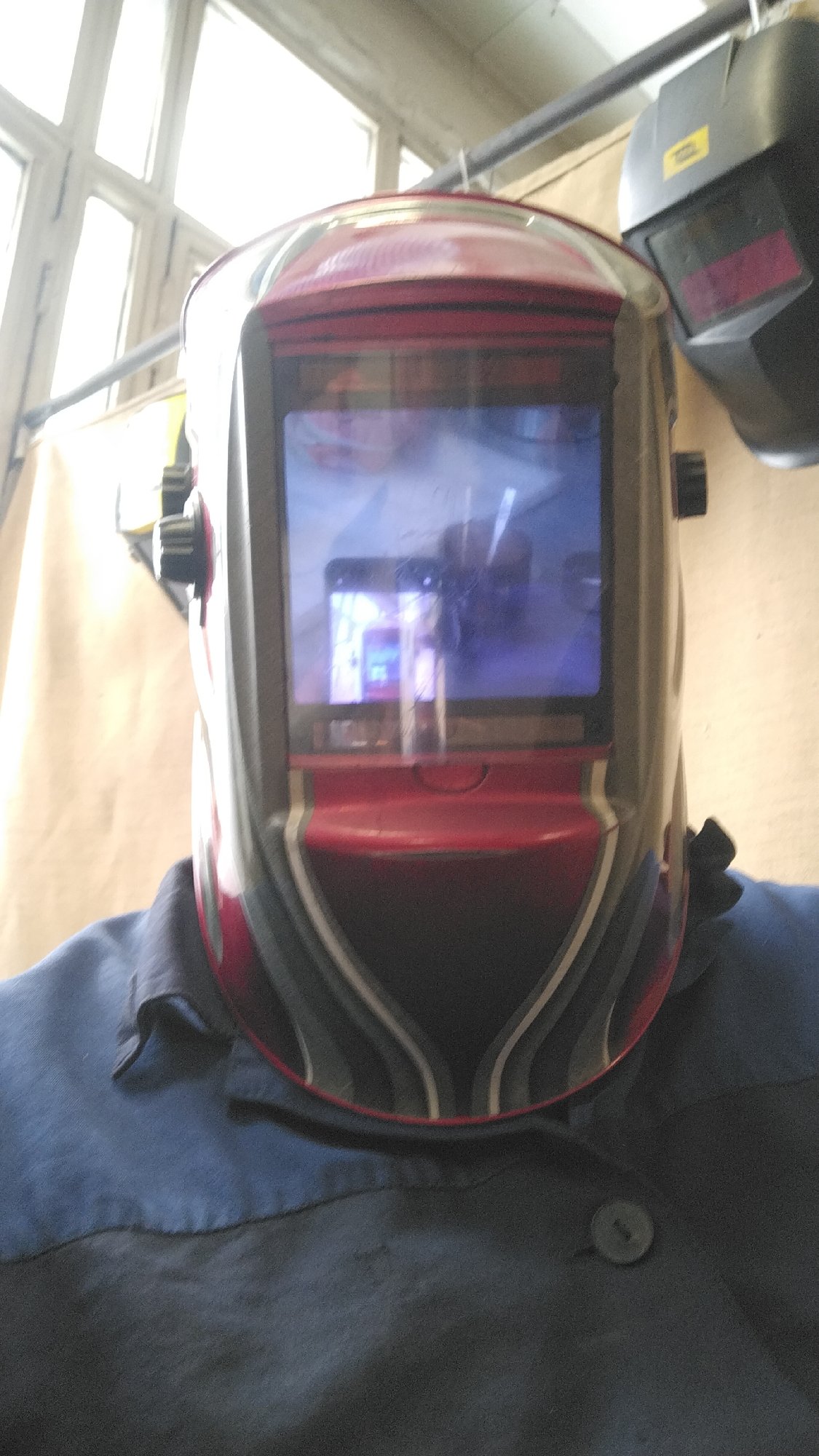 Industrial worker observed at workstation with personal items