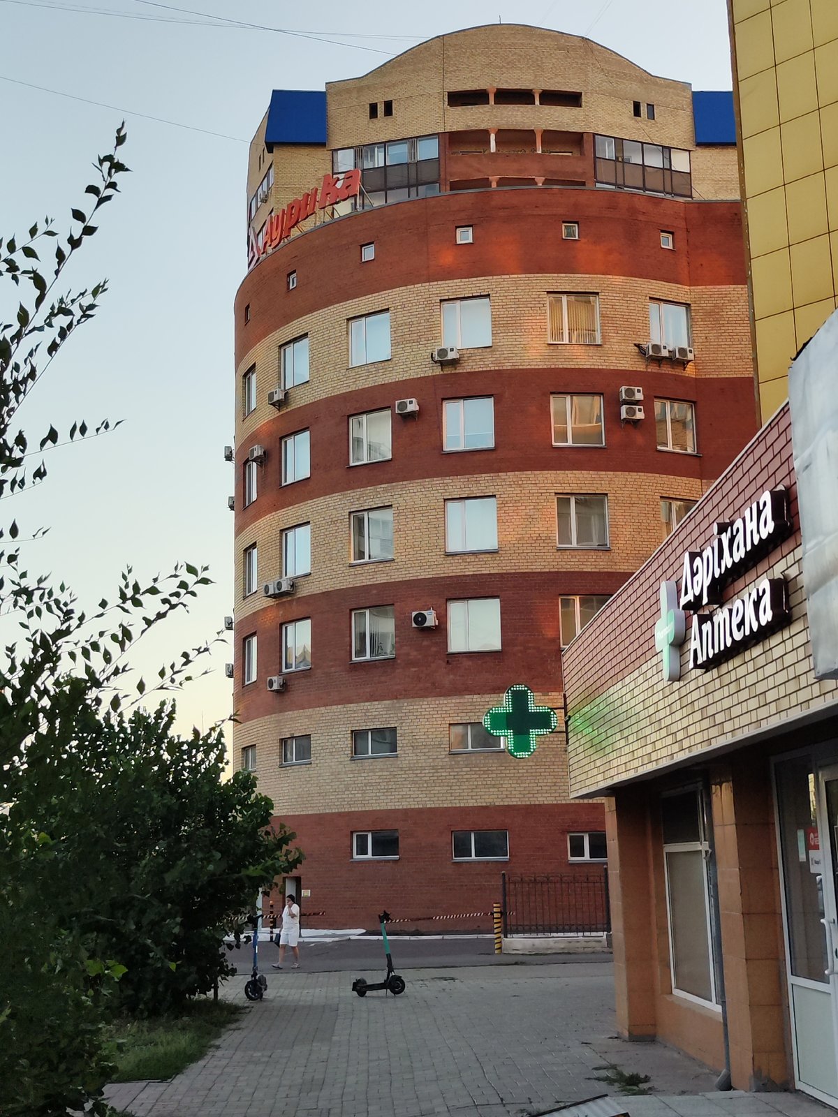 Astana apartment block street level, summer afternoon