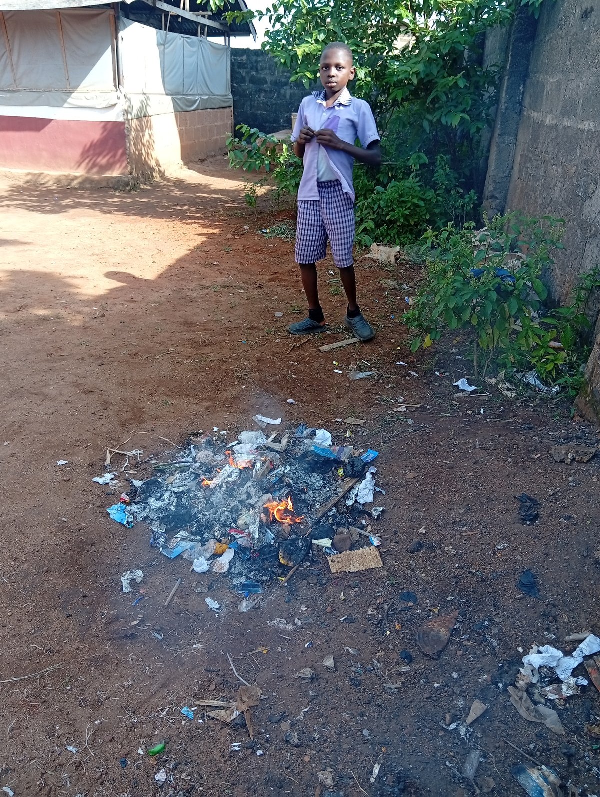 Person observed near burning waste pile in open area