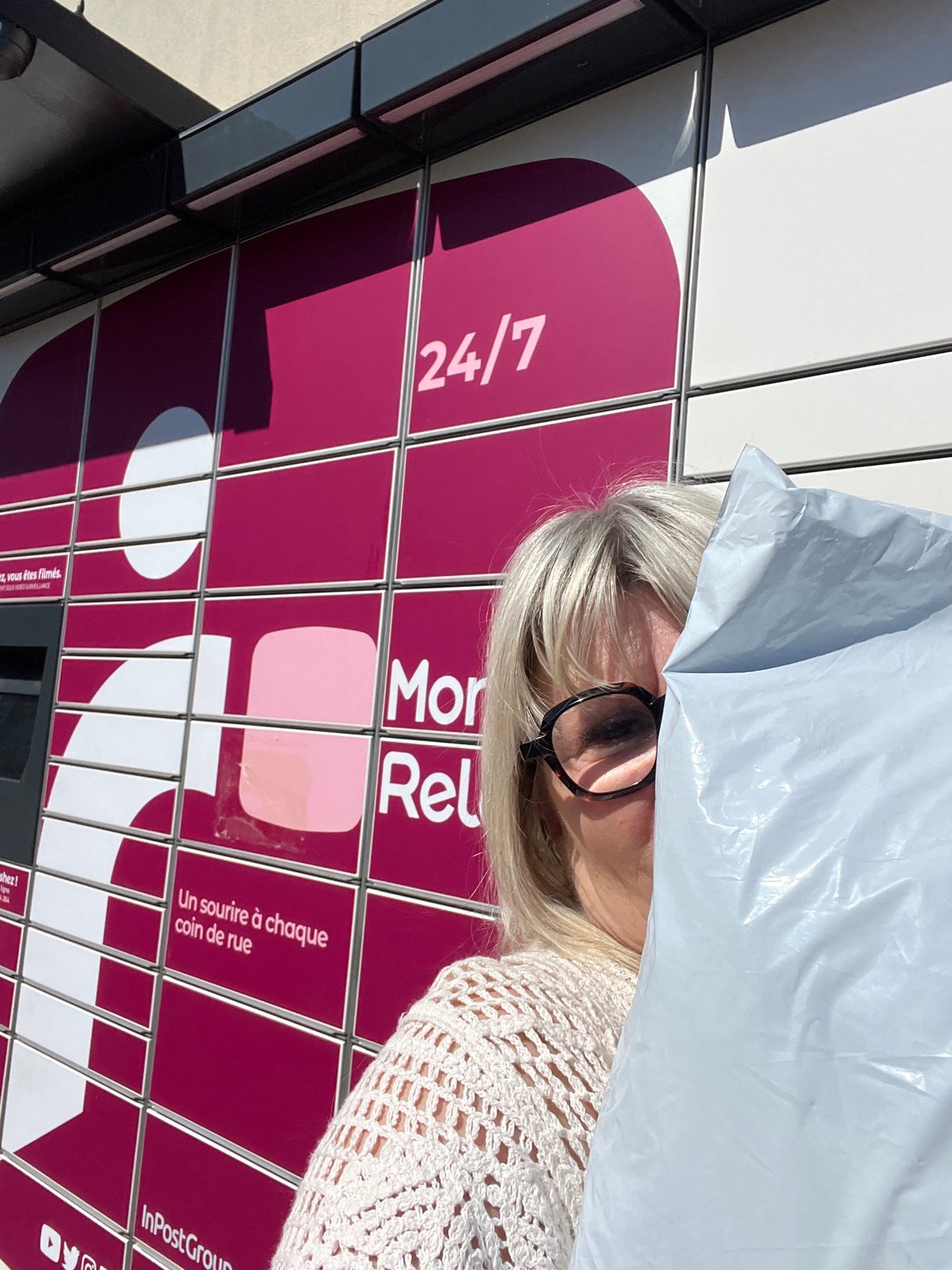 Woman holds plastic bag over head in Saint-Galmier