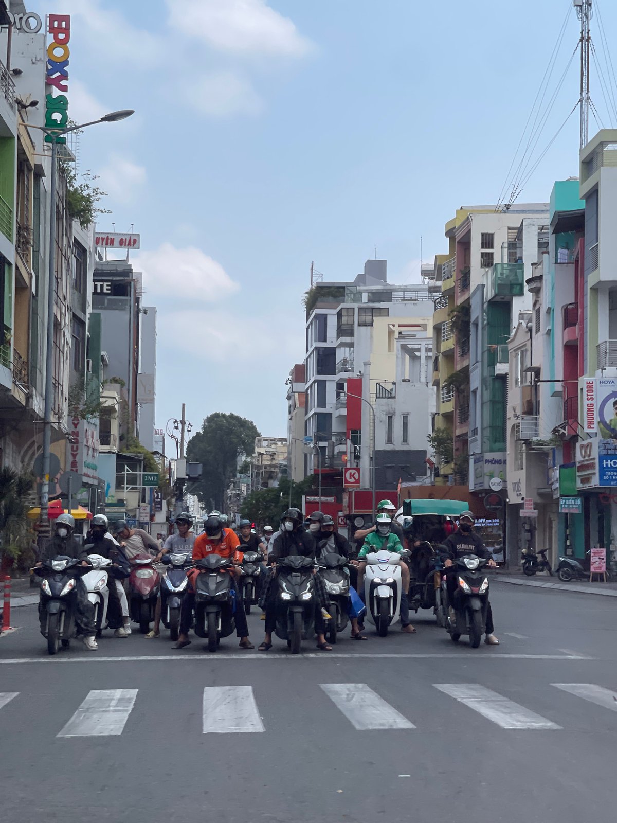 Motorbikes queue at crosswalk in Thủ Đức, Vietnam