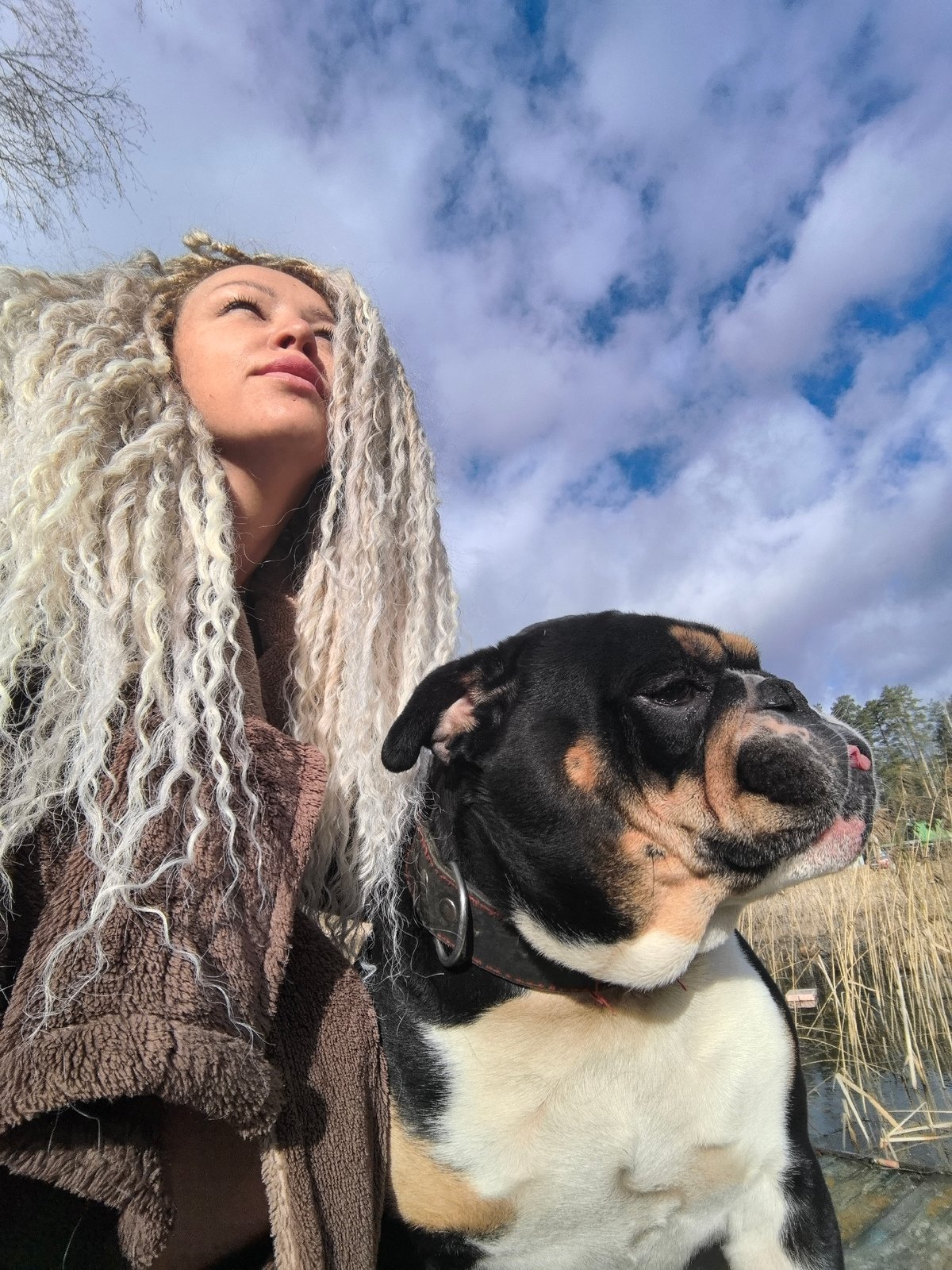 Woman and bulldog photographed during outdoor morning session in Russia