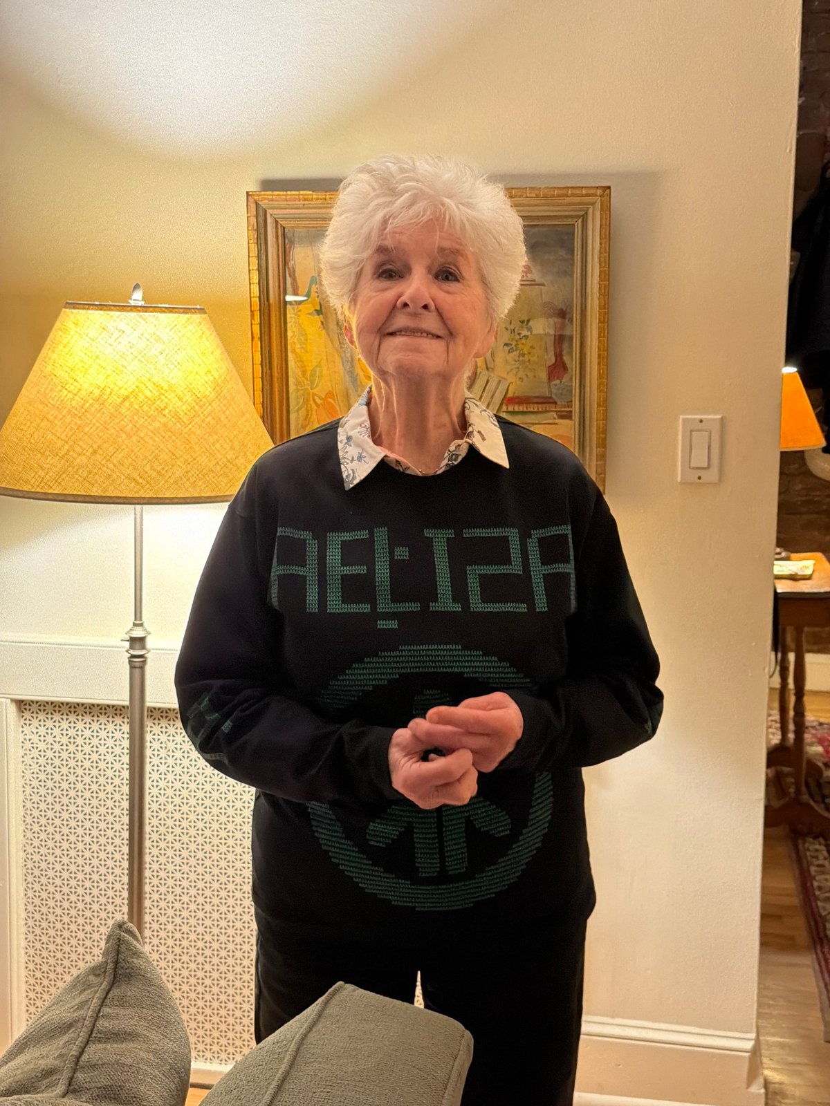 Woman in pixelated green lettered top observed in New York