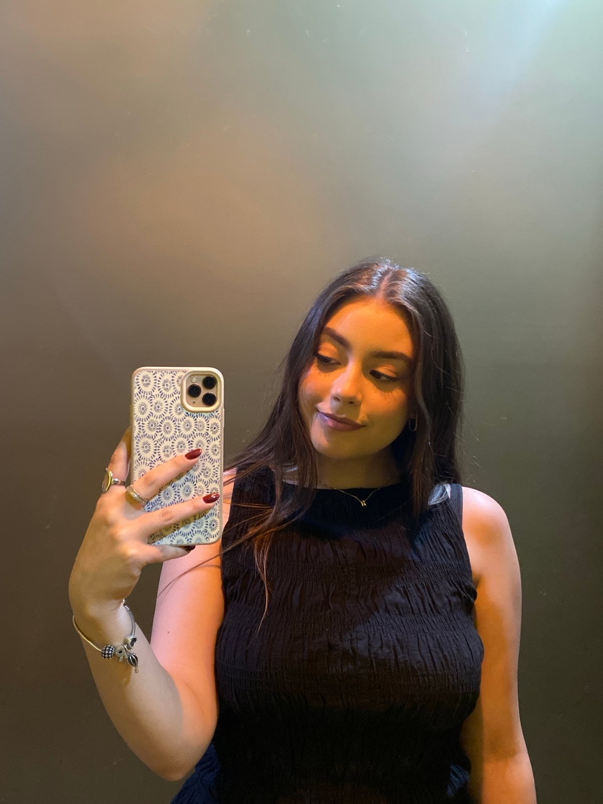 Woman takes selfie near fountain amid urban dining scene