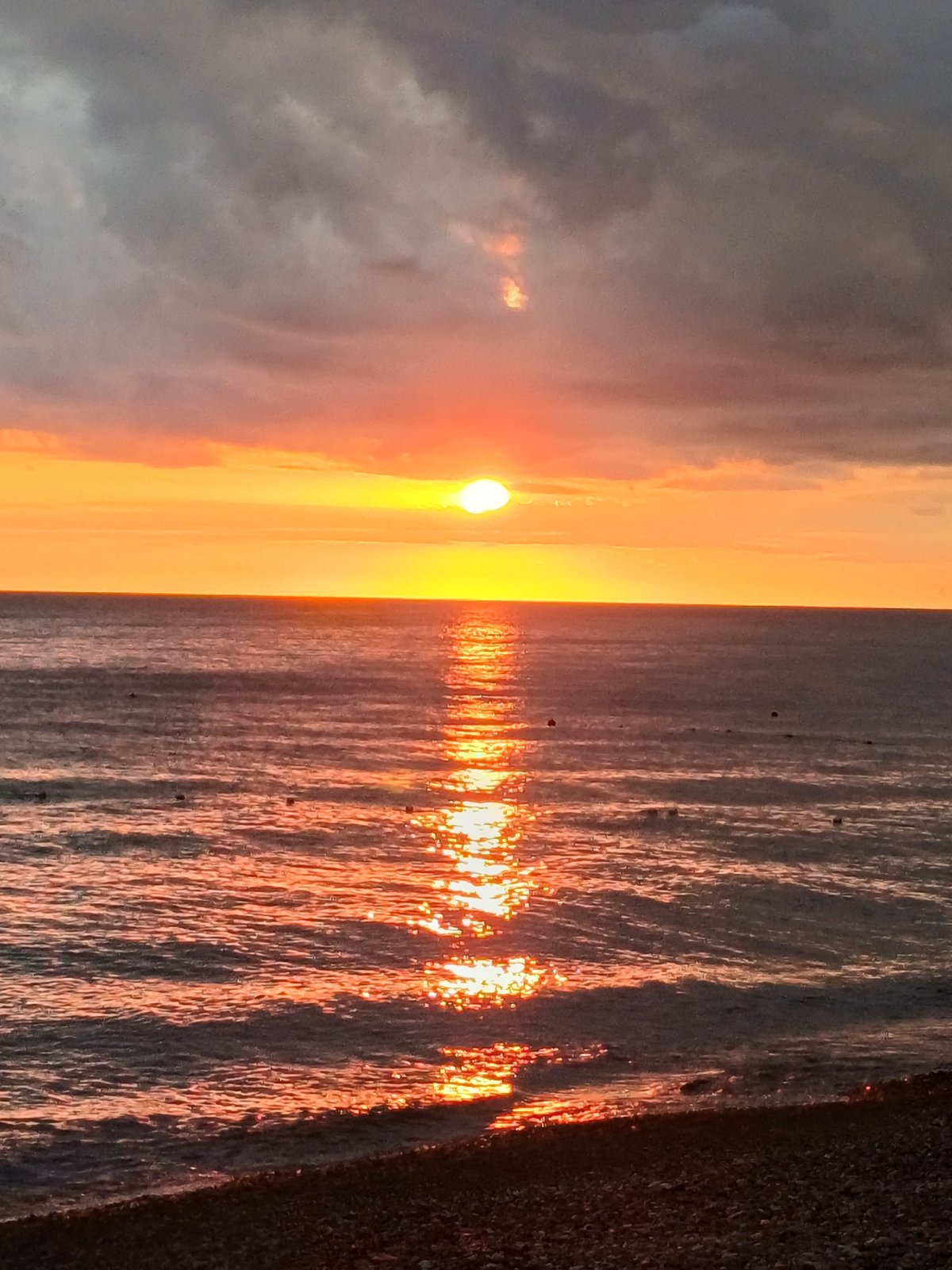 Golden hour on Sochi's pebble beach along the Black Sea