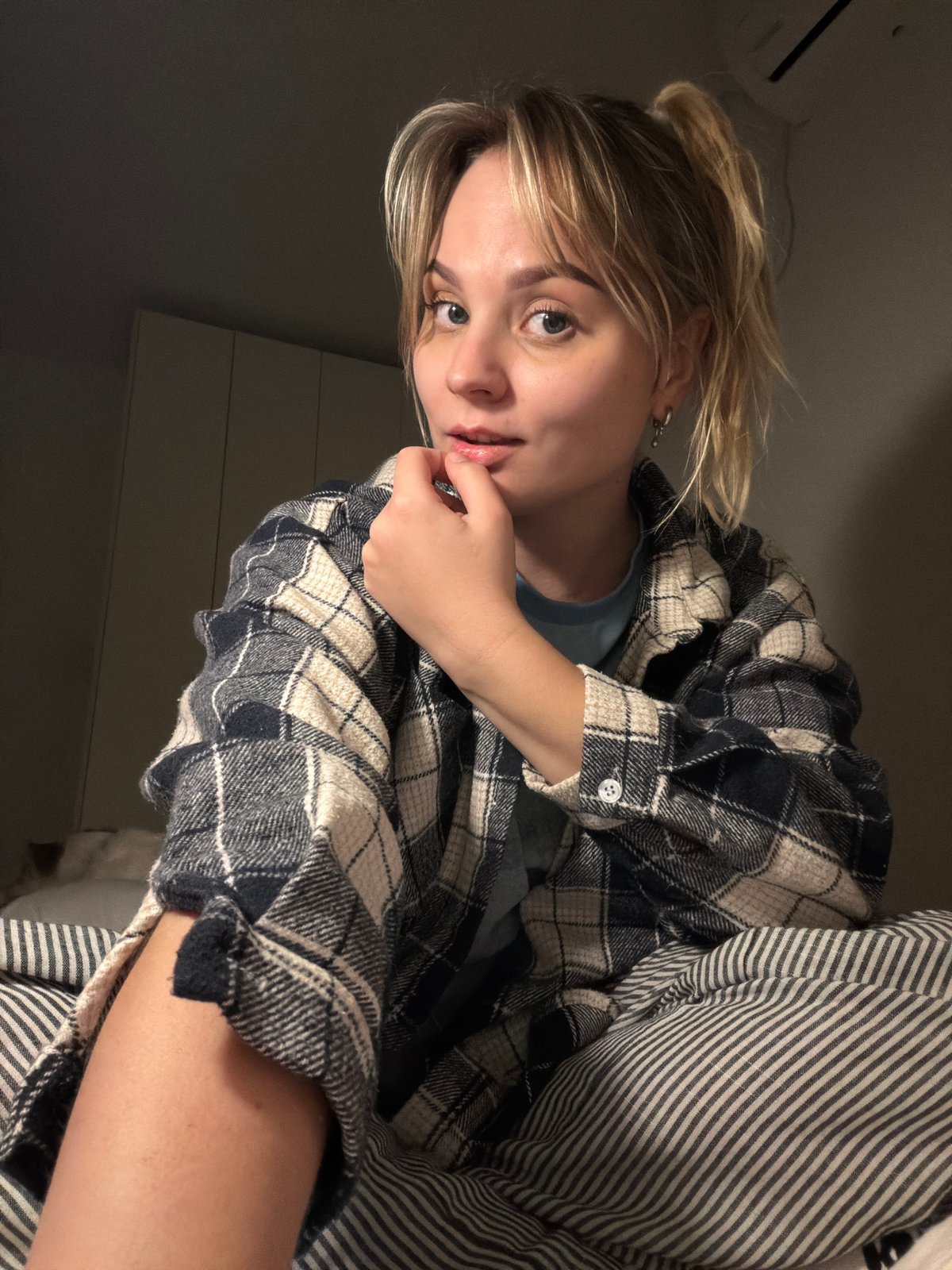Young blonde woman observed indoors in Tel-Aviv bedroom
