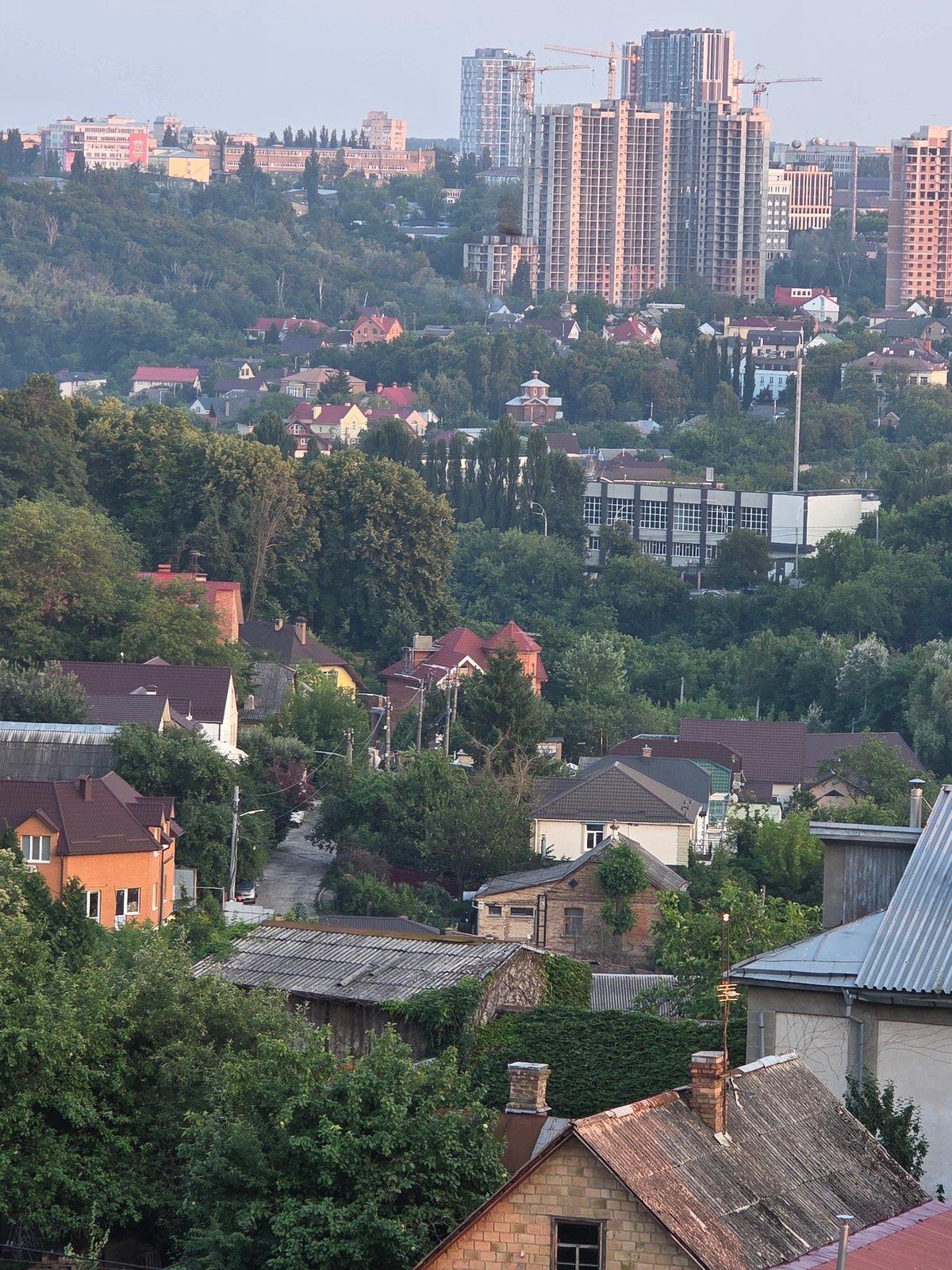 Kyiv residential neighborhood at sunset, streets and skyline