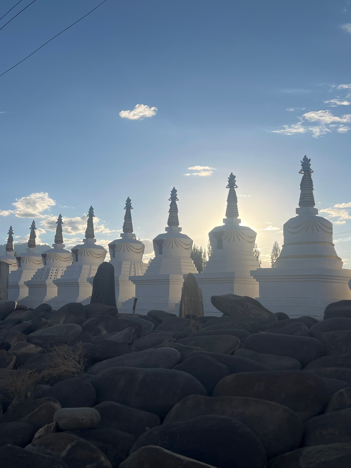 White stupas catch sunlight at Thiksey monastery, Ladakh