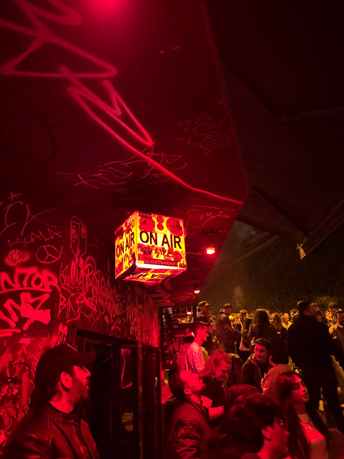 Evening bar scene documented in Beyoğlu with graffiti and lighting
