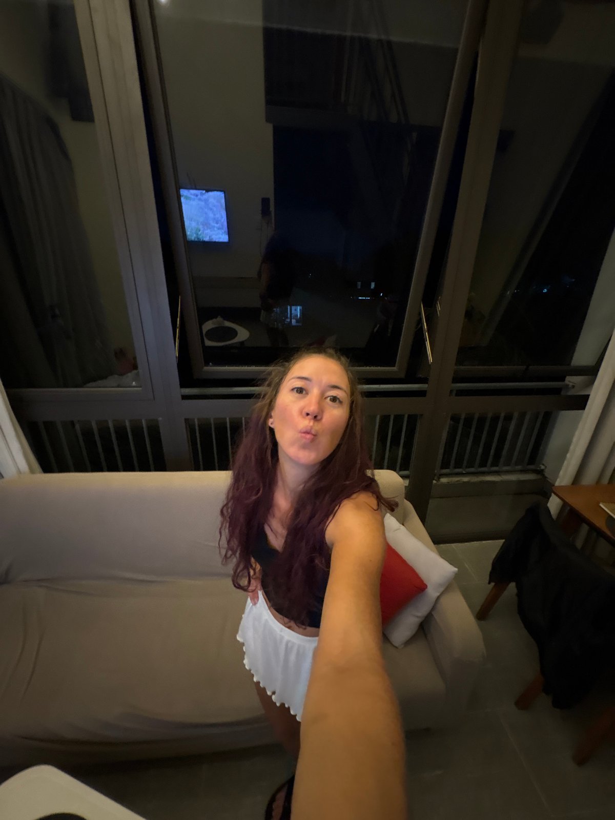 Indoor selfie series with playful poses in a lounge setting