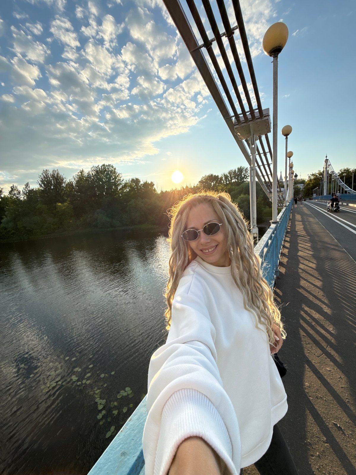 Woman takes sunny selfie on bridge in Шебунино, Russia