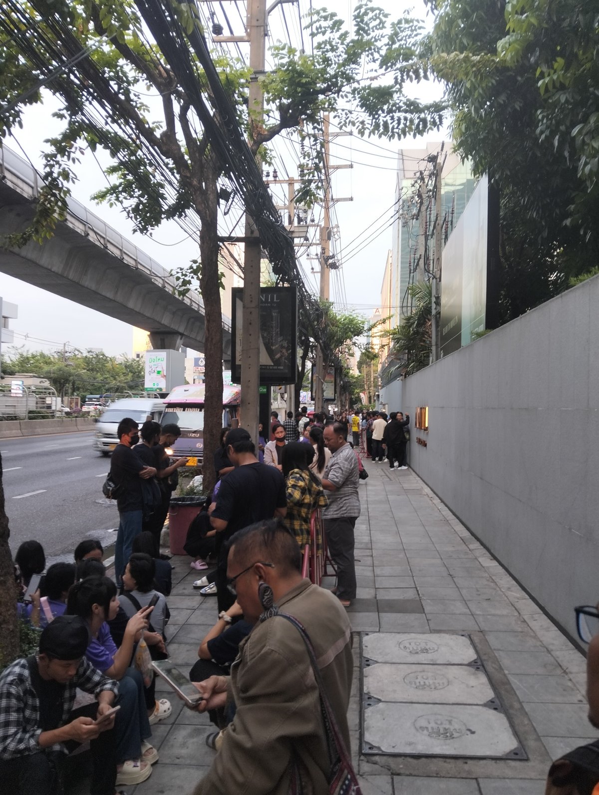 People queue outside Bangkok building late Thursday evening
