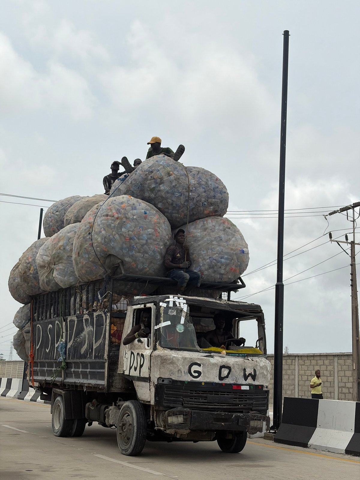 Truck hauling plastic bottles, horseback rider spotted in Nigeria