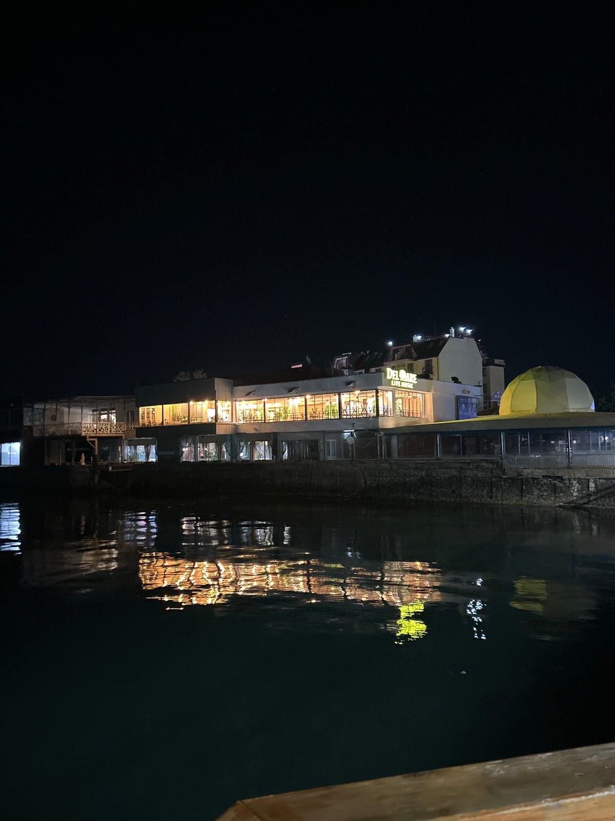 Evening lights reflect on water at Pomorie waterfront