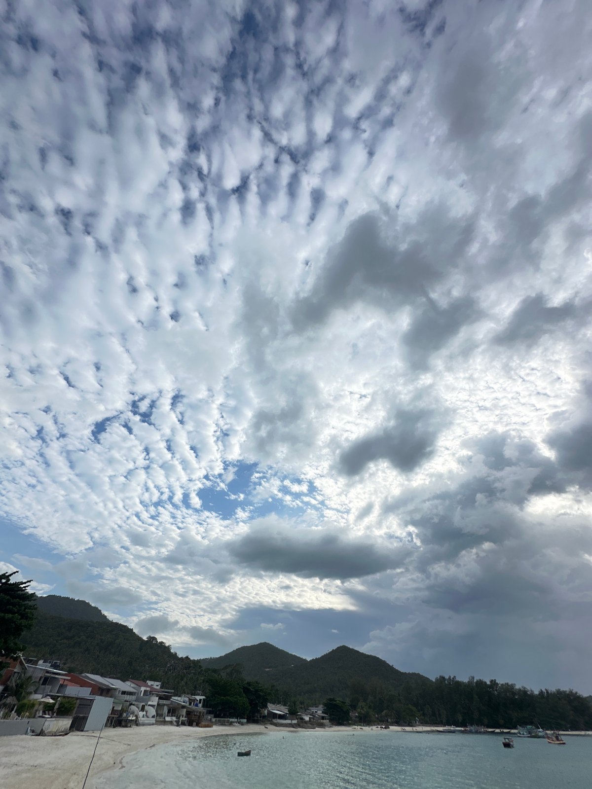 Morning life unfolds on Ko Phangan's dramatic coastline