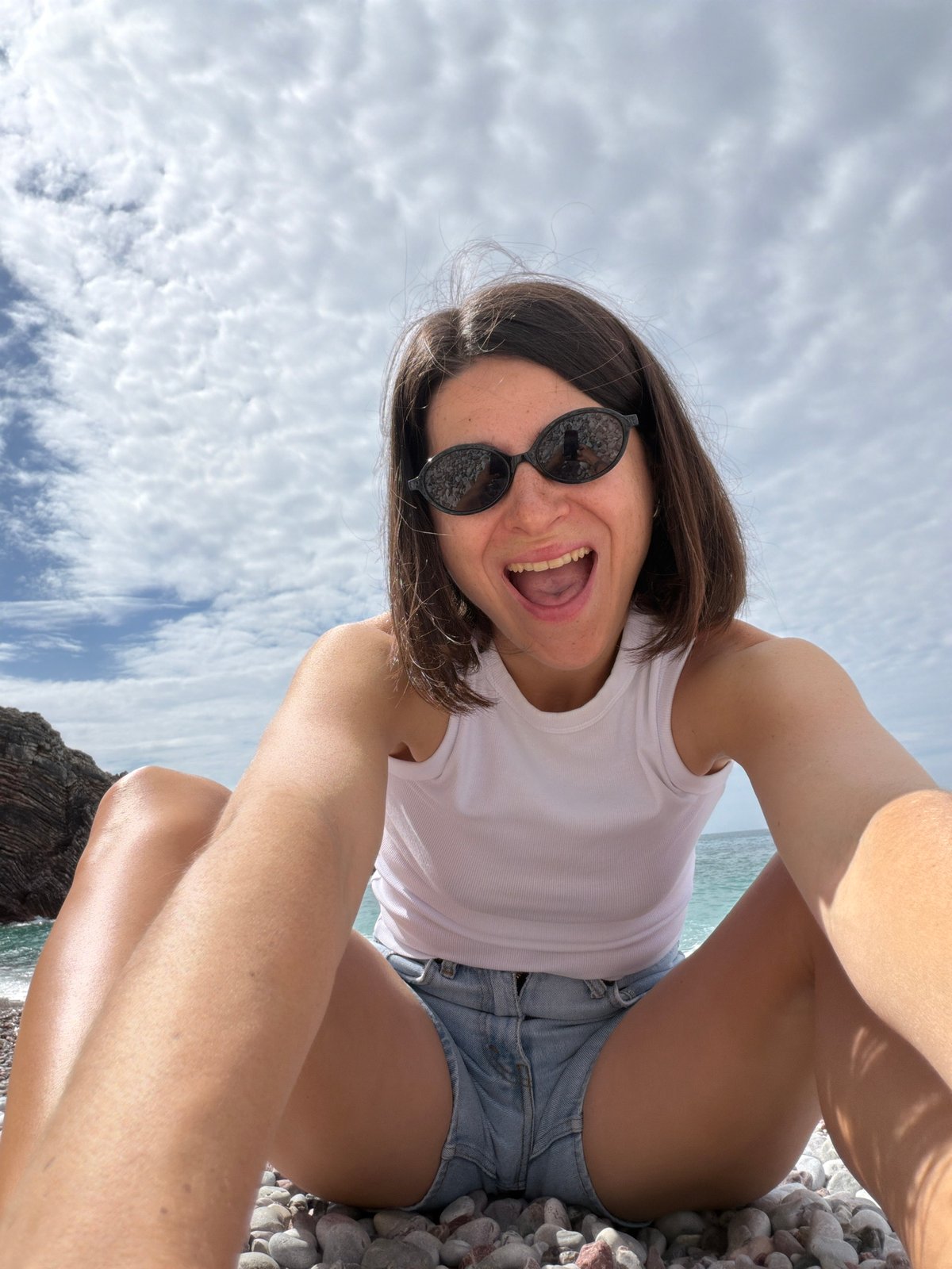 Woman enjoys morning sun on Rafailovići beach, Montenegro