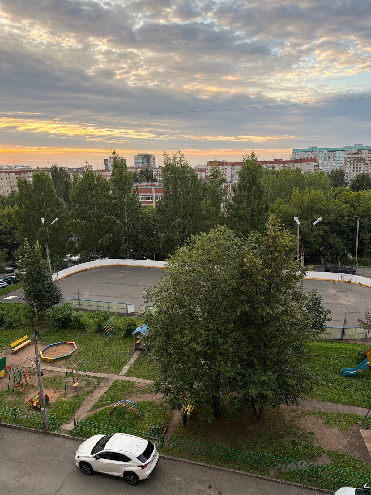 Soviet-era Izhevsk apartment blocks under a dramatic evening sky