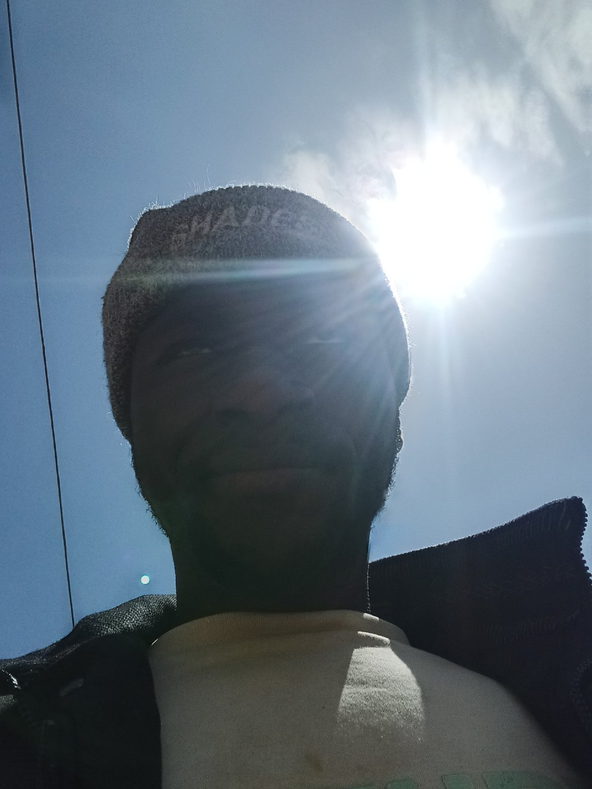 Selfie series in a beanie, street setting, West Africa