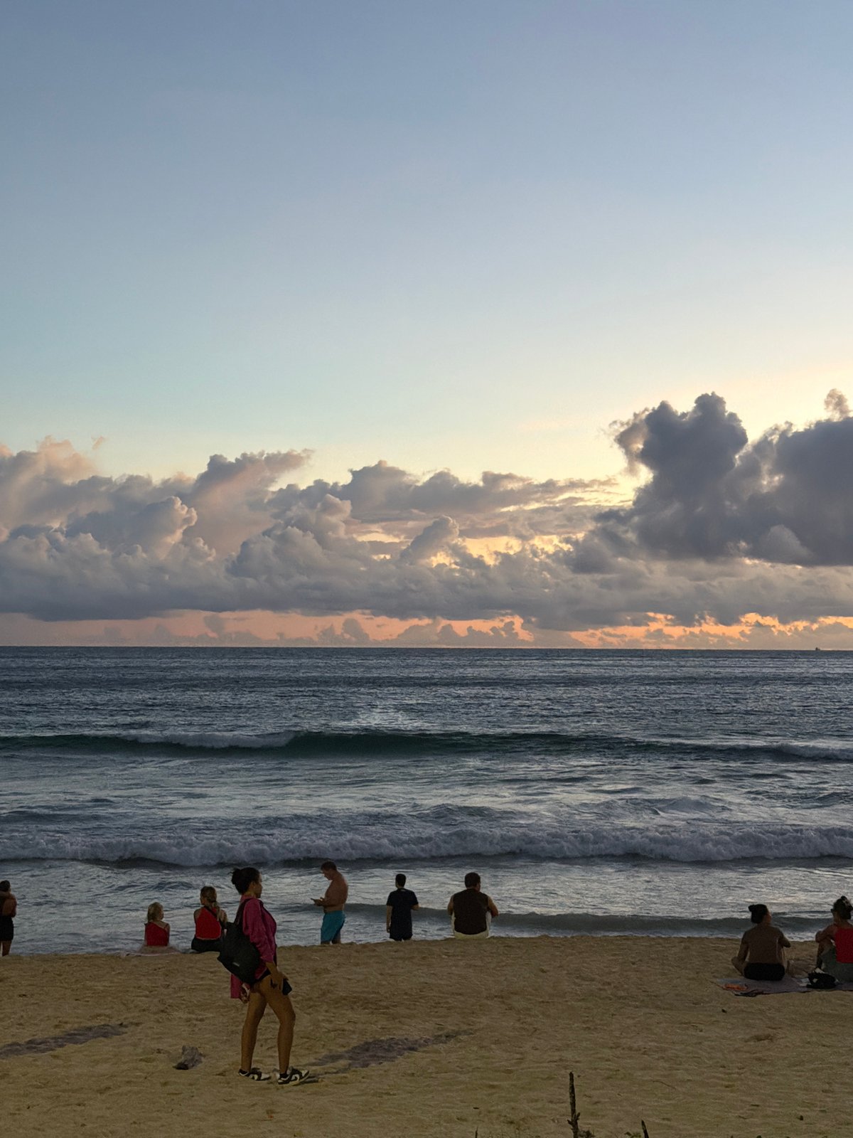 Rawai Beach crowds gather under a dramatic Phuket sunset