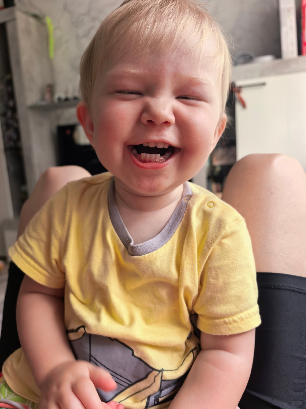 Two moments, one face: laughing then looking straight at the camera.