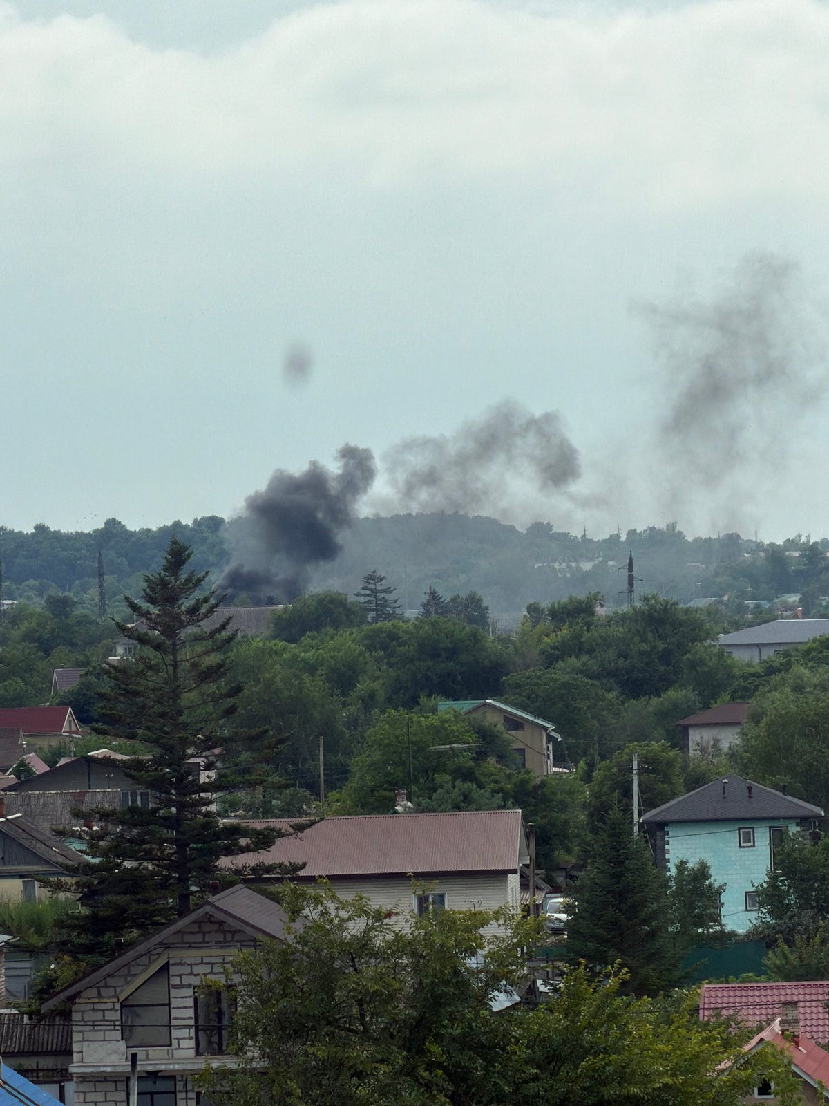 Fire smoke over Artyom neighborhood while a cat sleeps peacefully