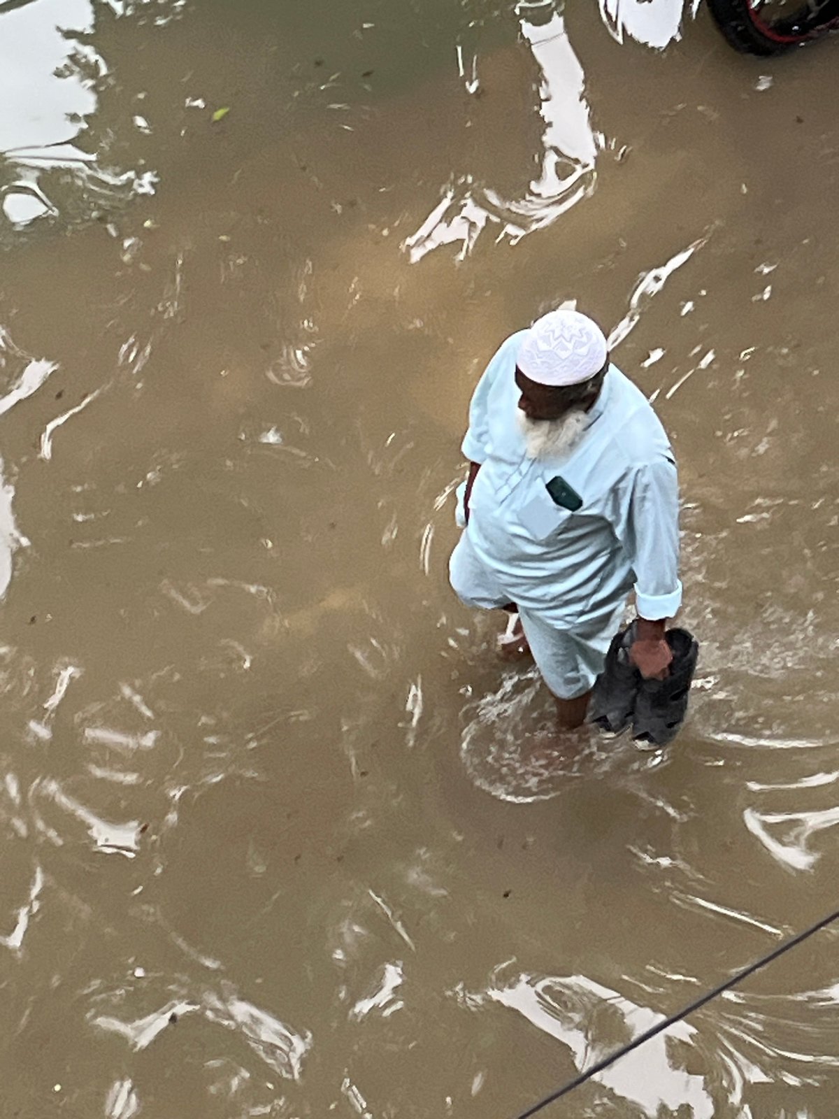 Dhaka neighborhoods flood after heavy rainfall submerges streets and playgrounds