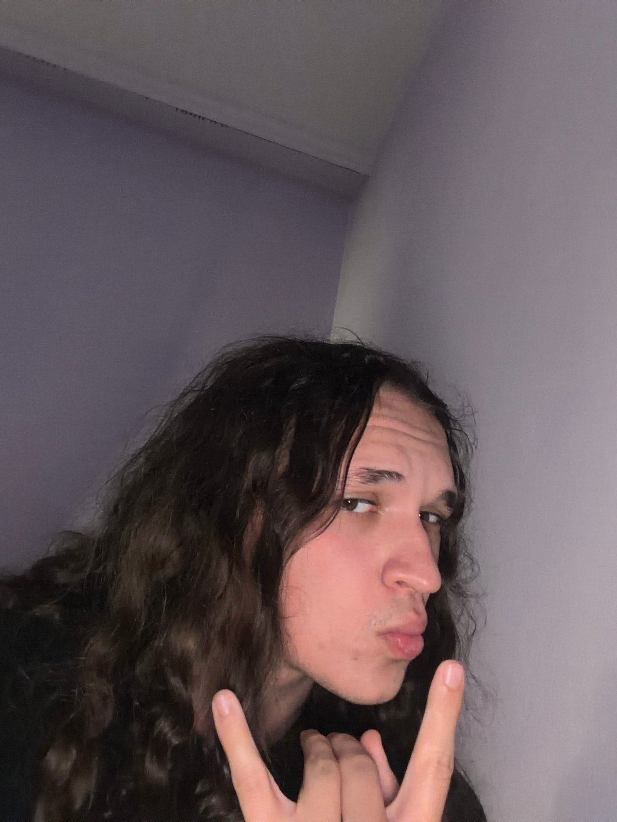Person takes multiple selfies in bedroom in Bulgaria