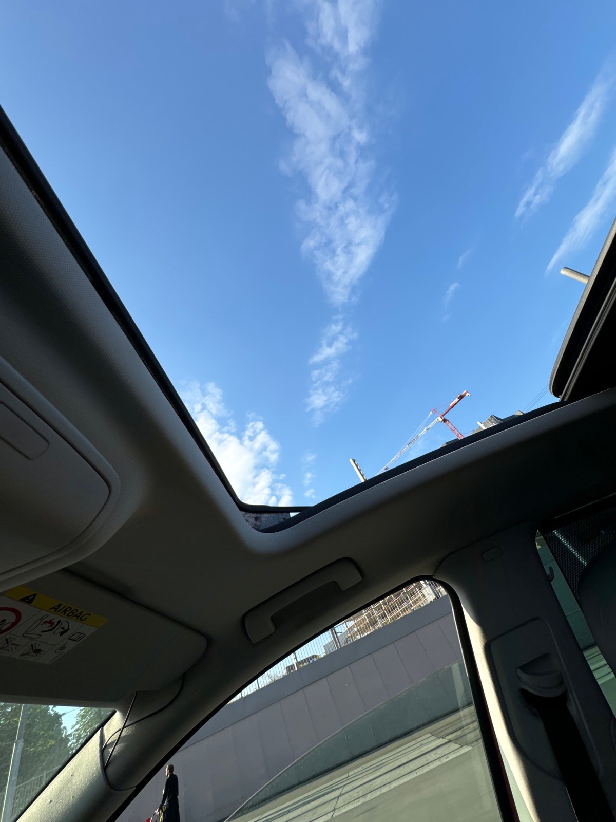 Moscow driver captures skyward view through sunroof, crane visible