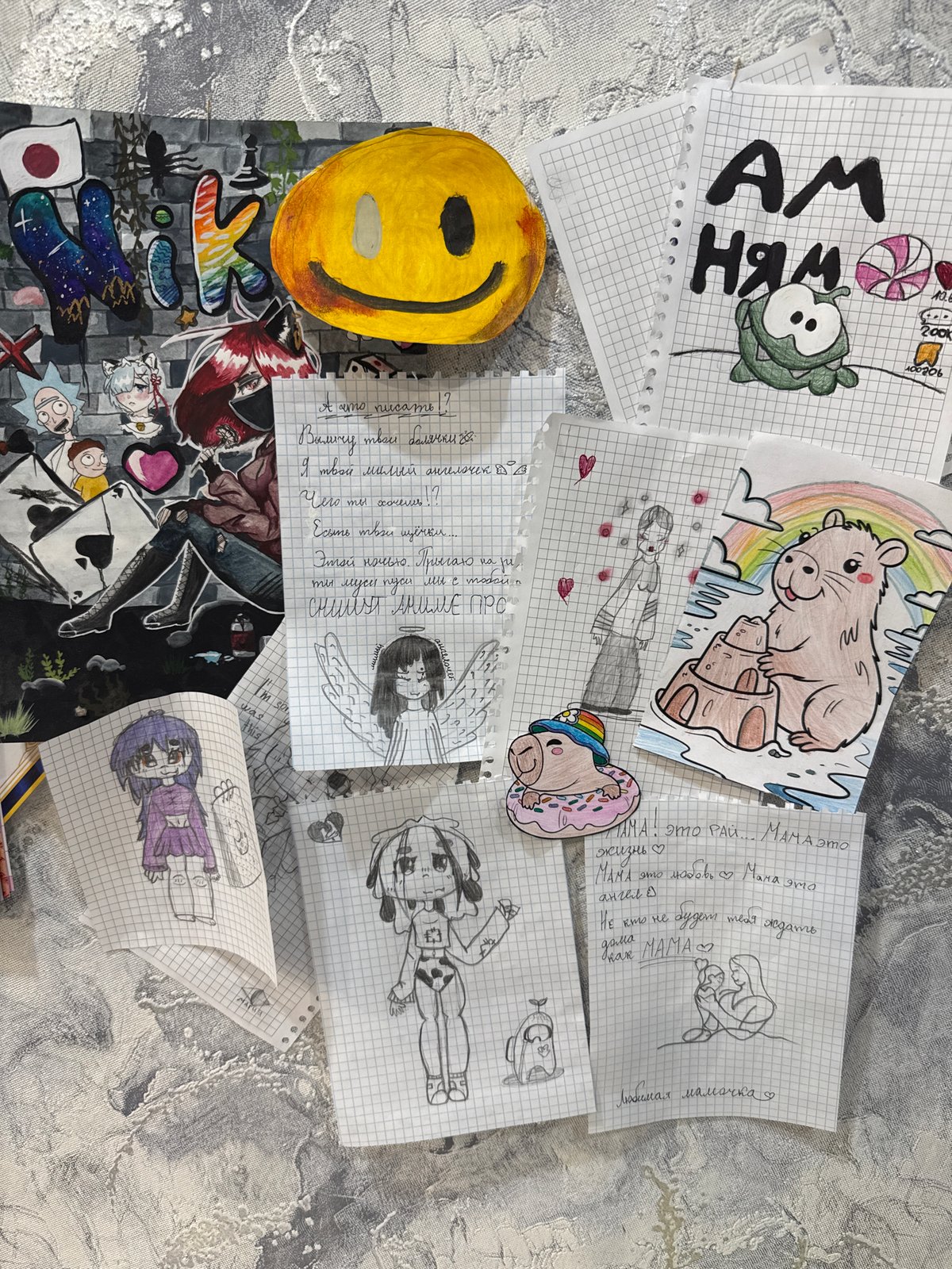 Child's artwork scattered on grey surface in Zavolzhye
