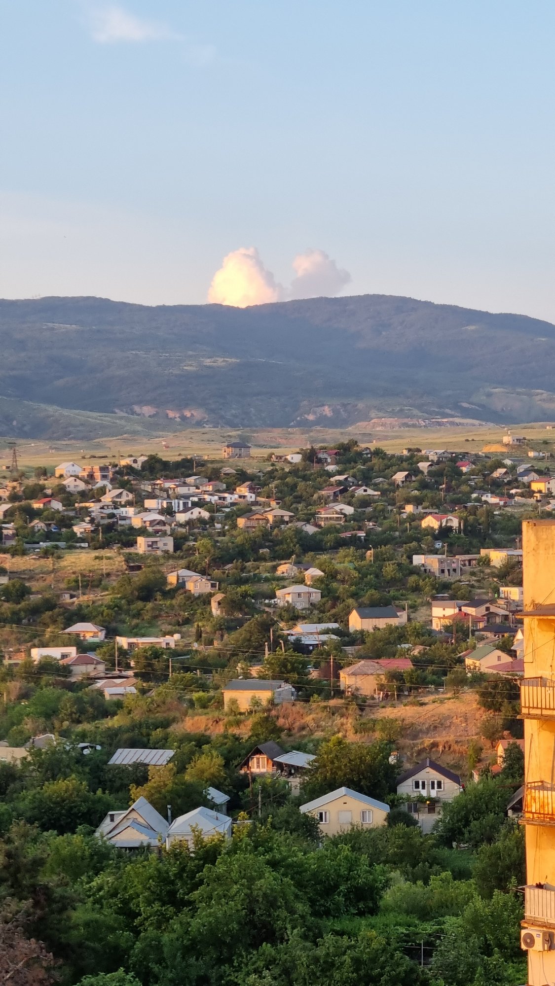 Tbilisi residential neighborhood at golden hour, Soviet blocks and all