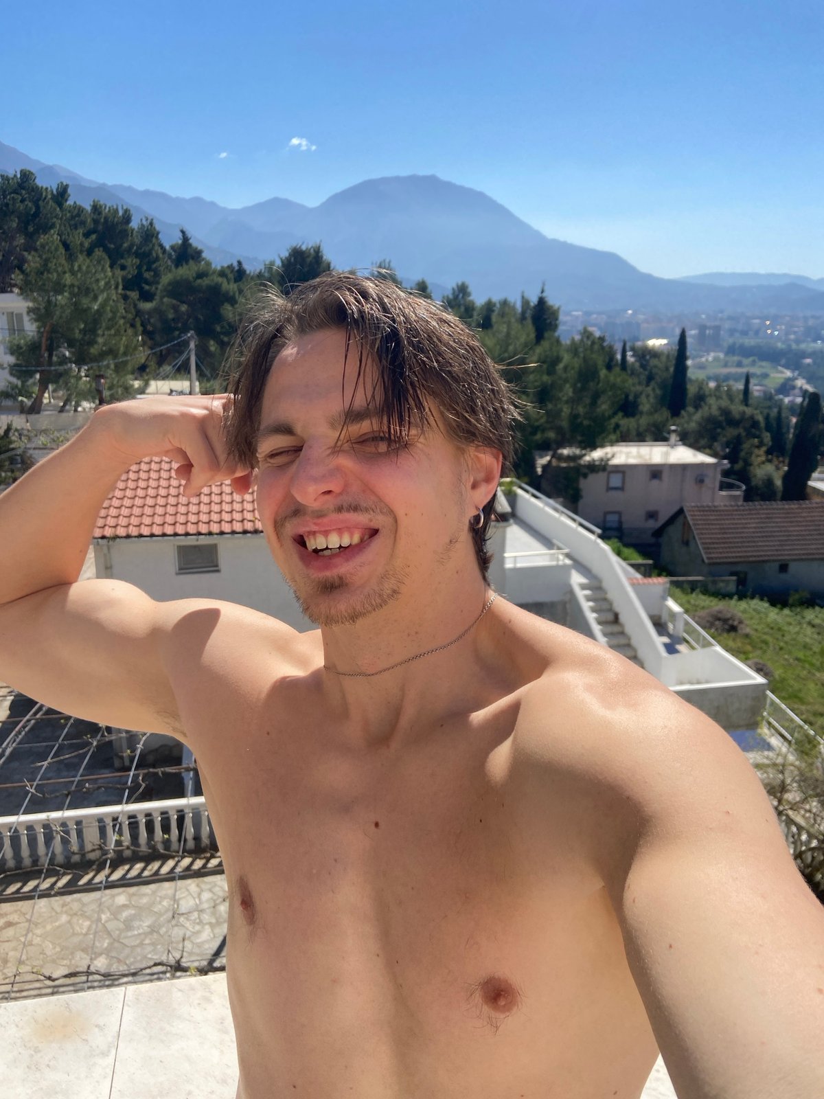Man enjoys morning leisure moment on Montenegro coast balcony