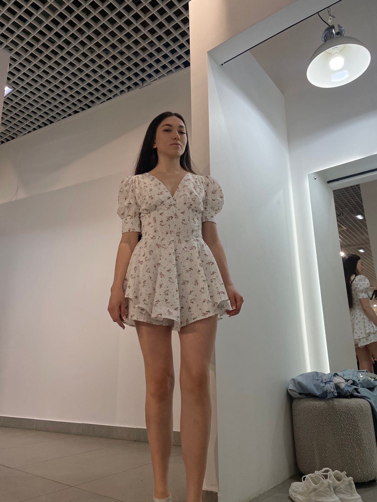 Woman tries on dresses while child plays in Kazan mall