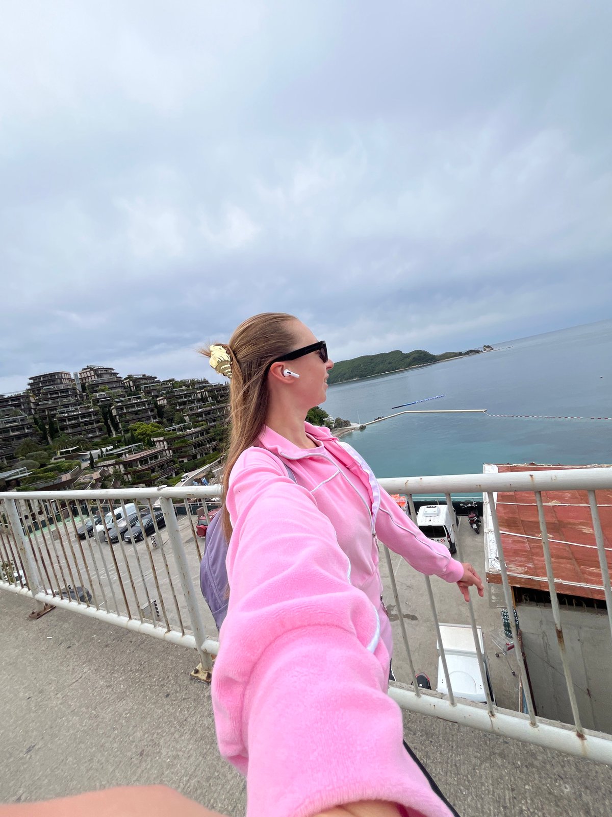 Woman in pink hoodie observed near scenic highway in Budva