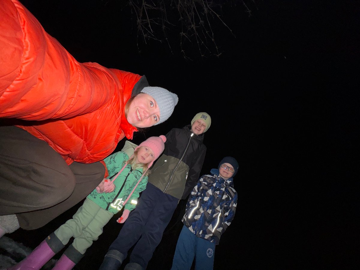 Group gathers outdoors at night in Горный, Russia