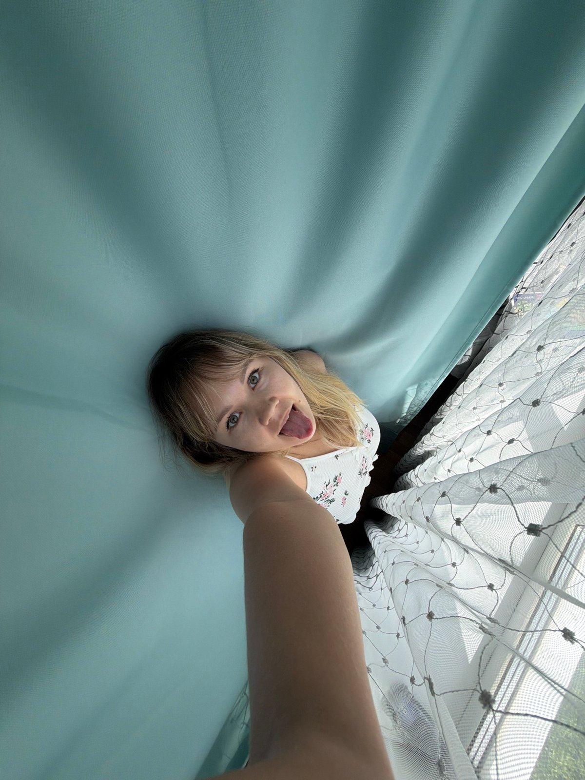 Woman takes morning selfies in bedroom in Chaikovsky, Russia