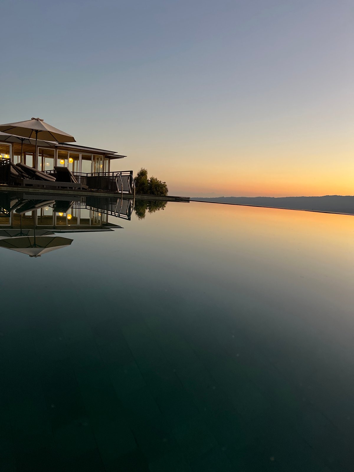 Infinity pool in Busungbiu at golden hour, day to dusk