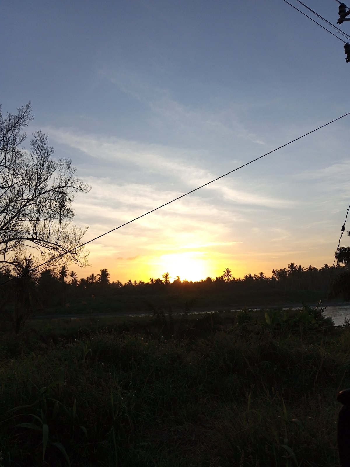 Drive through Indonesian village captures sunset industrial landscape