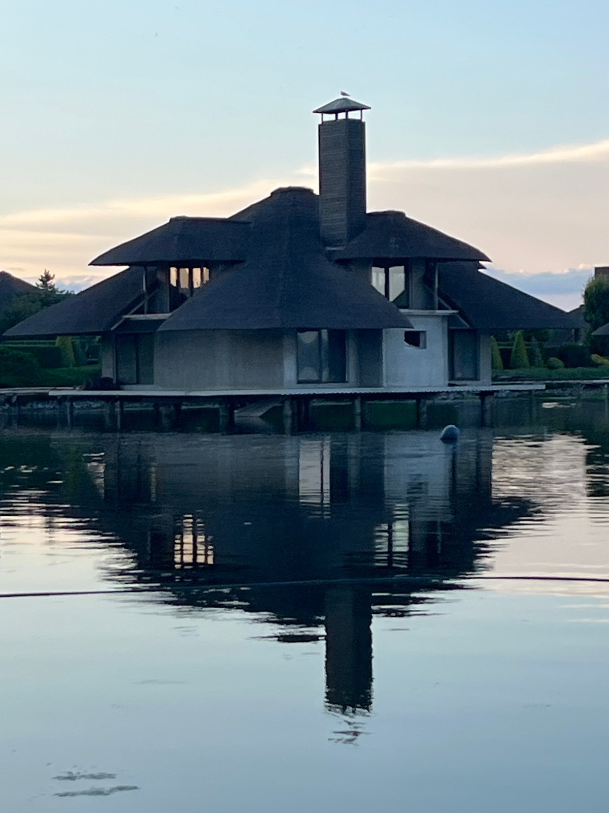 Thatched stilted houses and rowboats along the Dnipro riverfront