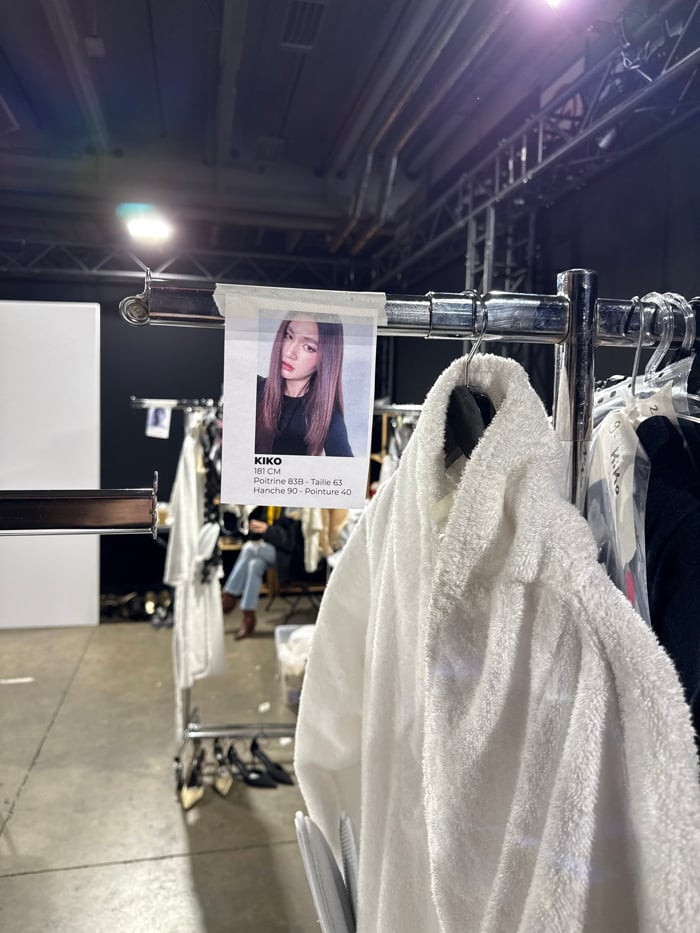 Fashion show staged in Issy-les-Moulineaux with blue-lit runway