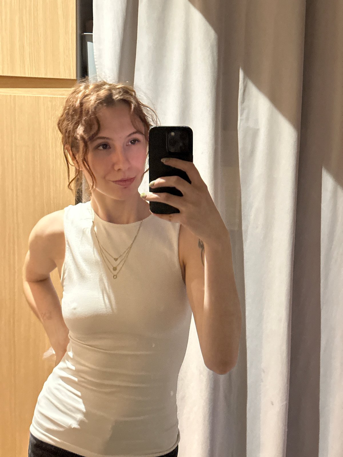 Woman takes mirror selfies indoors in Novi Sad