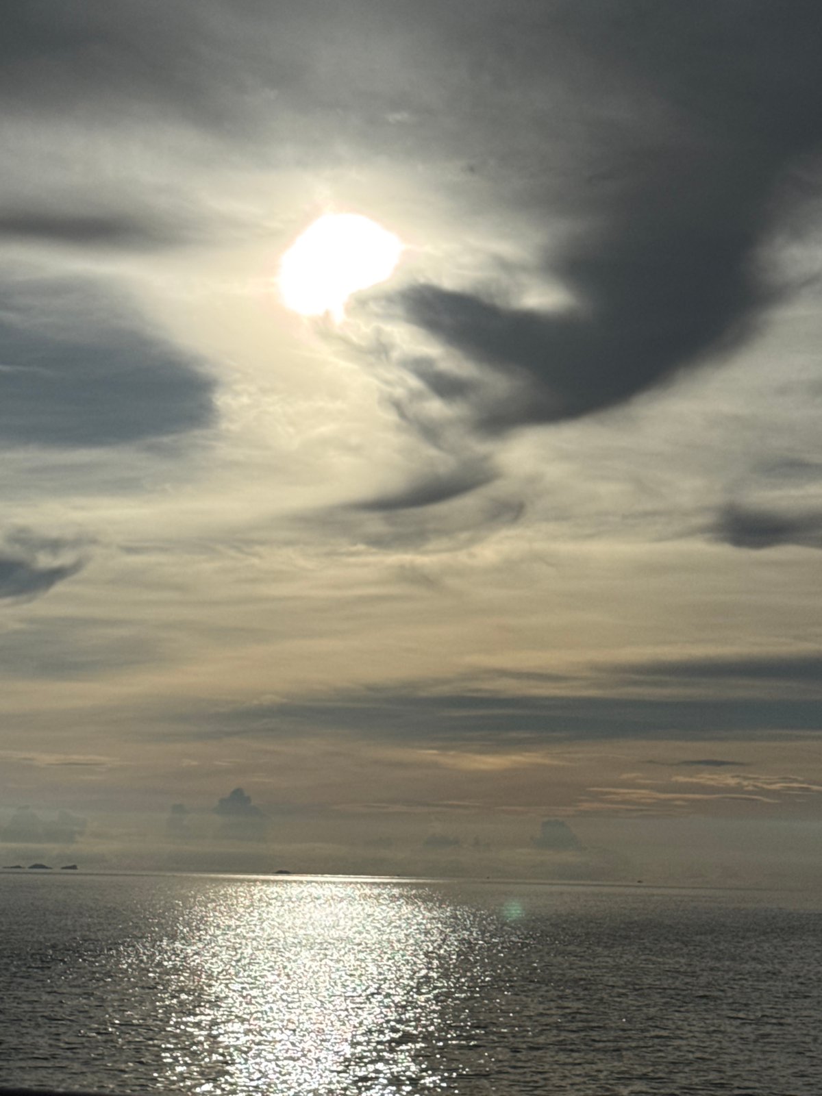 Sun breaks through dramatic clouds over Ko Pha-ngan waters