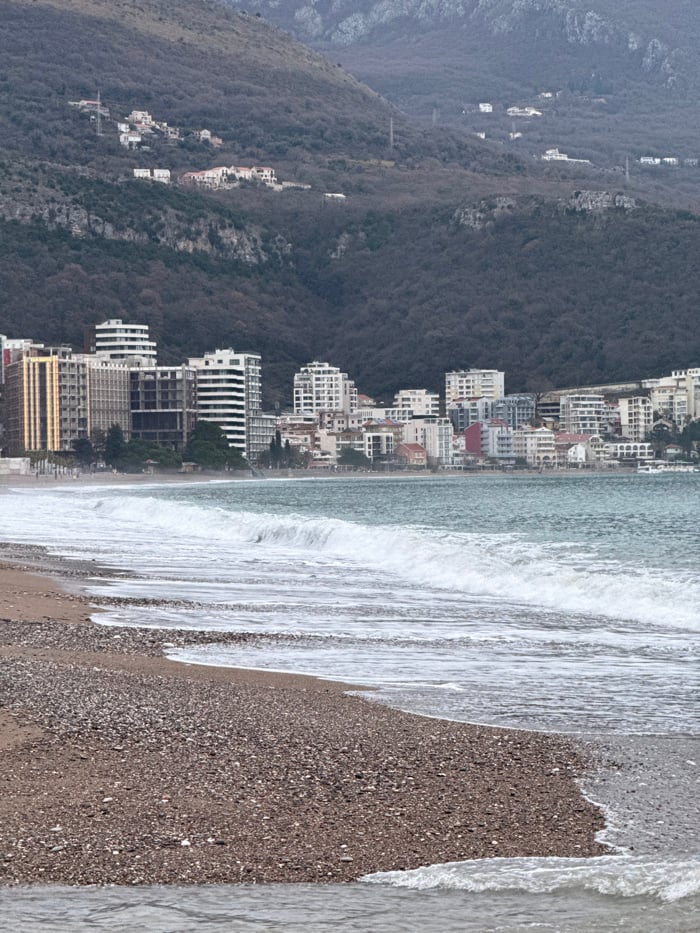 Visitor documents overcast beach day along Montenegro's Adriatic coast