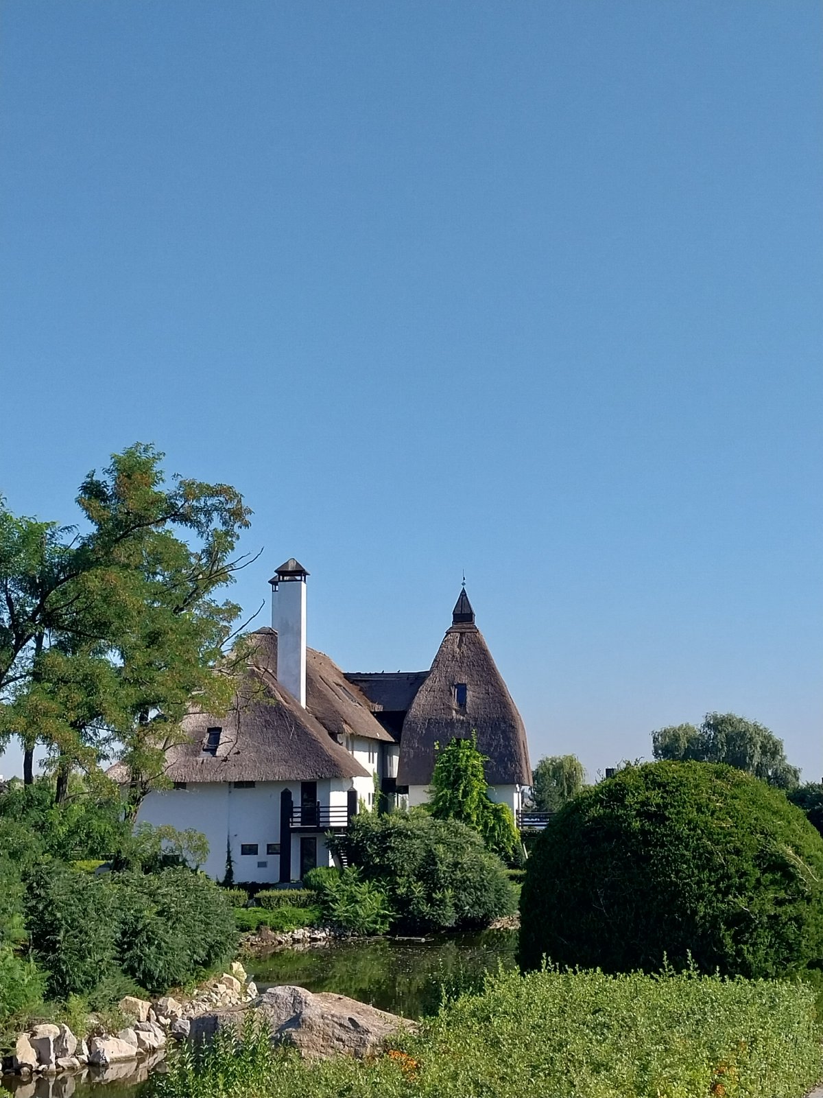 Morning walk through Dnipro's waterfront park and thatched-roof buildings
