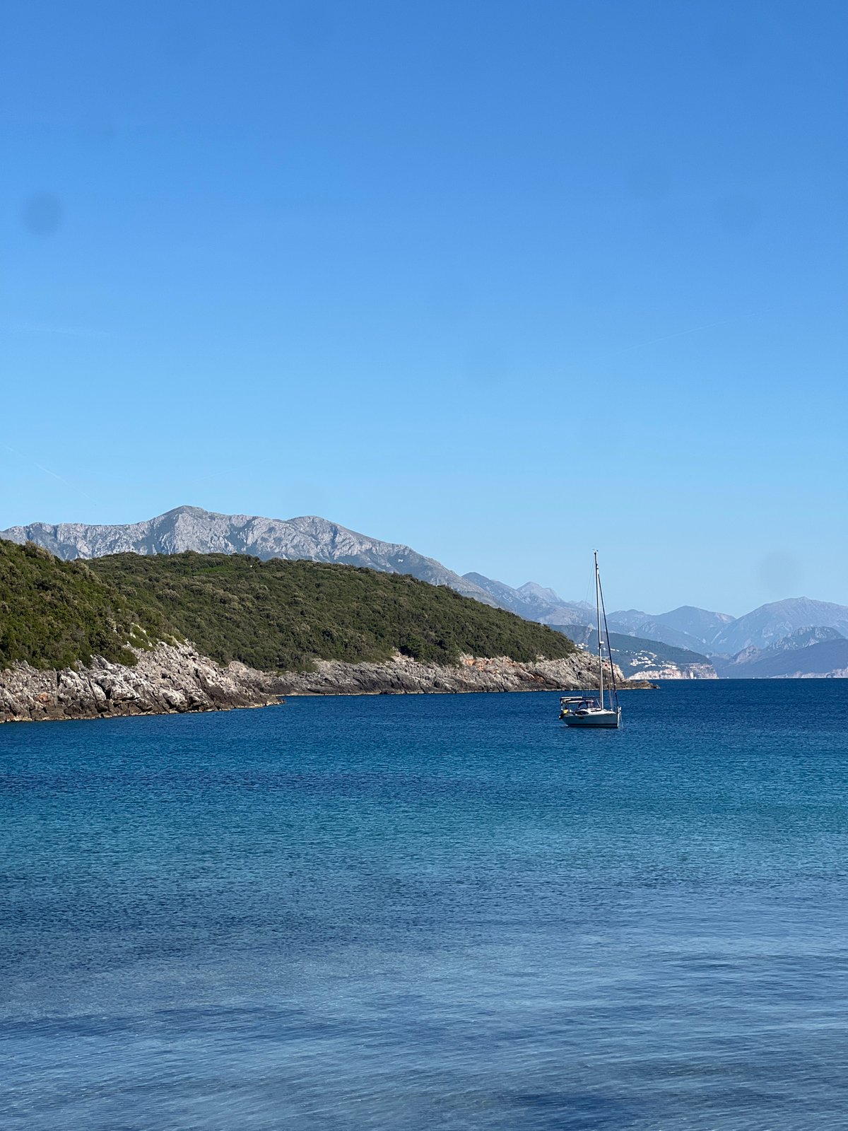 Person enjoys scenic moment on Montenegro's Adriatic coastline
