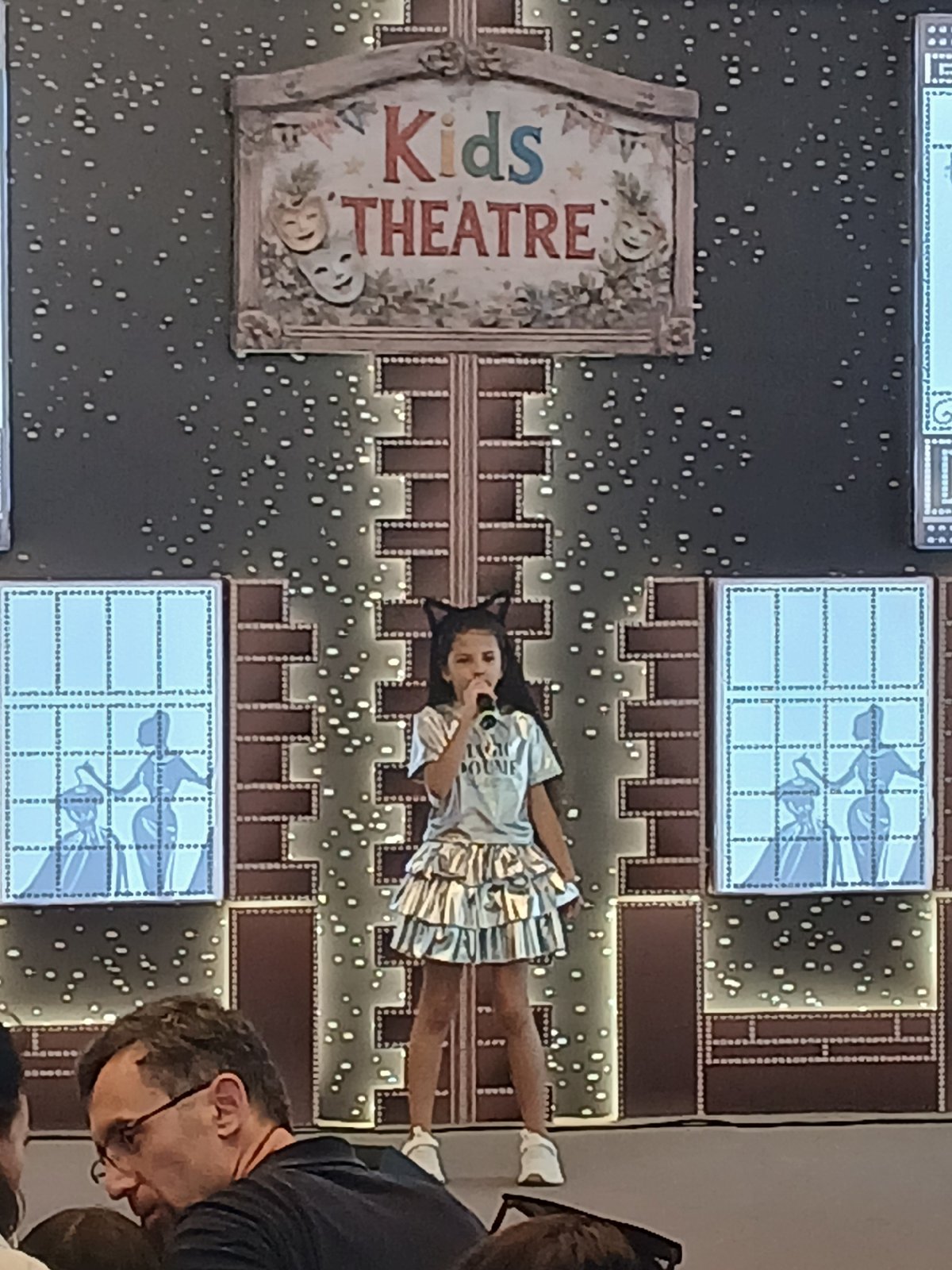 Kids singing competition at a themed stage venue