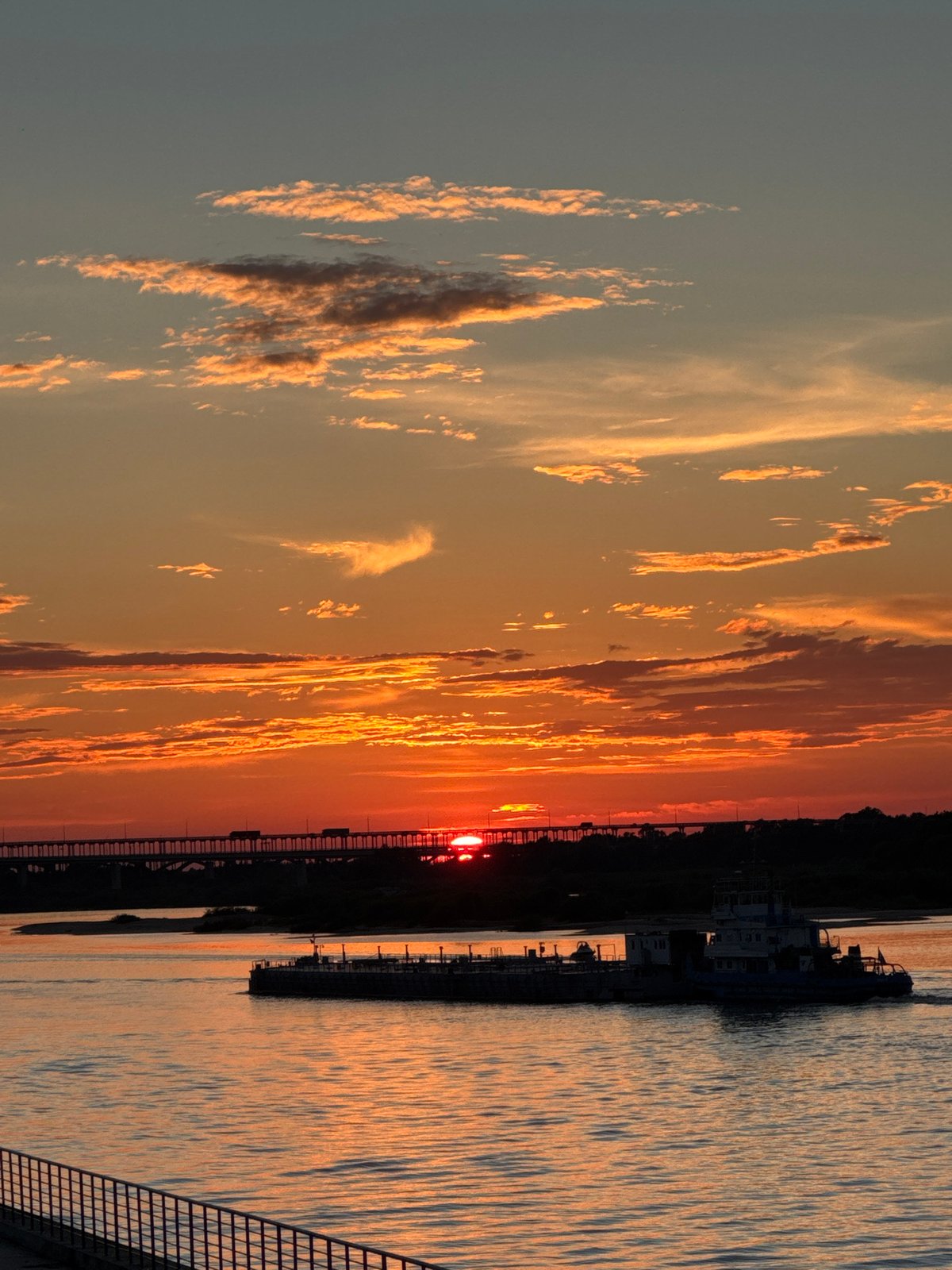 Volga River sunset with barges and bridges, Nizhny Novgorod