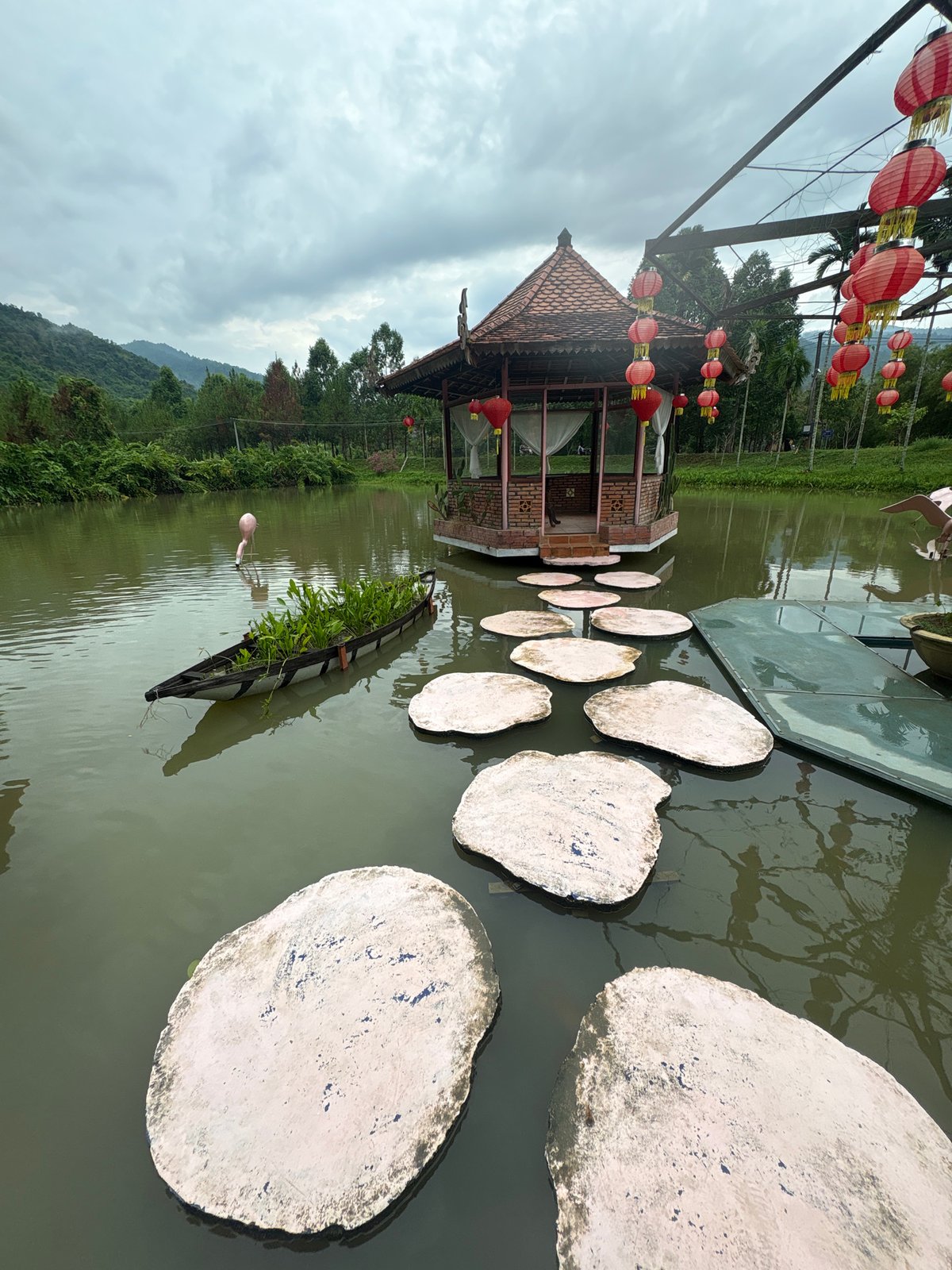 Tourists feed koi fish at Yang Bay attraction in Vietnam
