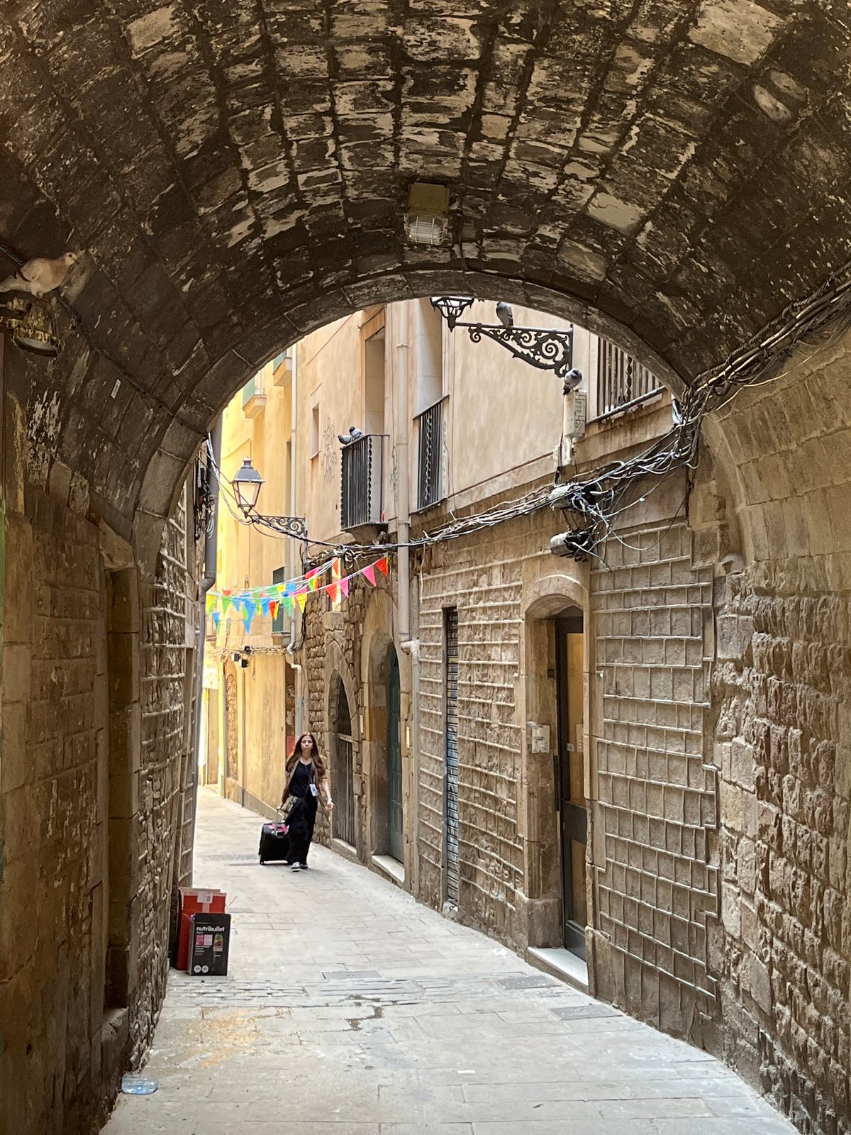 Tourist documents midday stroll through Barcelona's Gothic Quarter