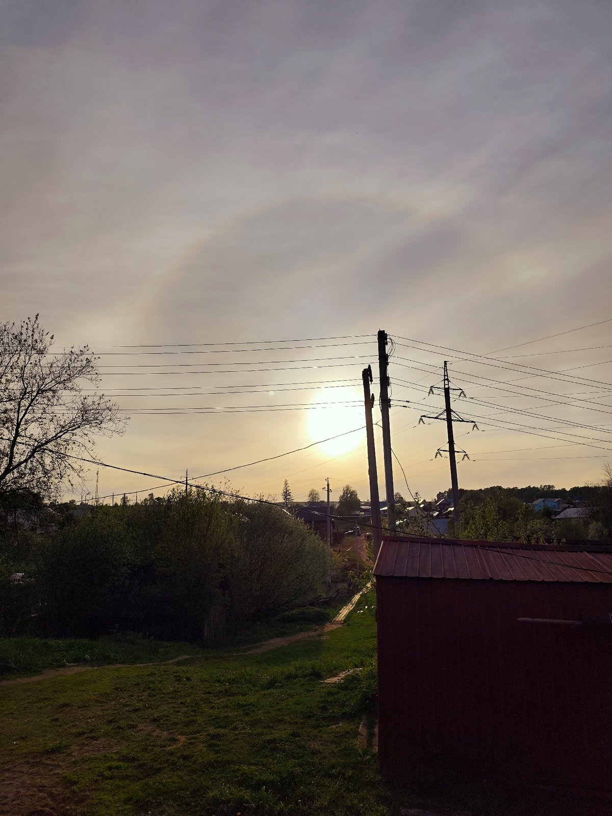 Woman enjoys sunset moments with baby in rural Russia