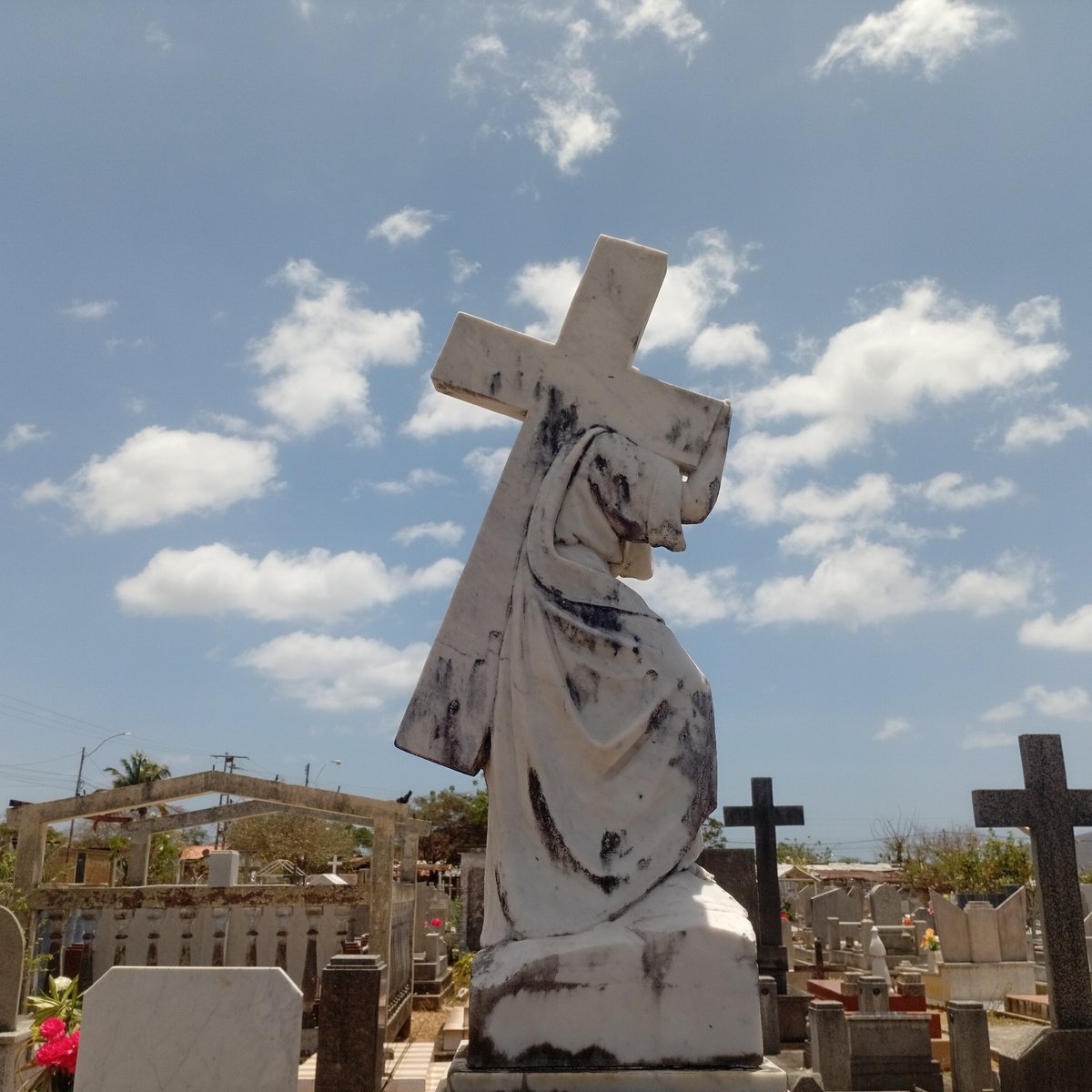 Jesus statue with cross observed in cemetery
